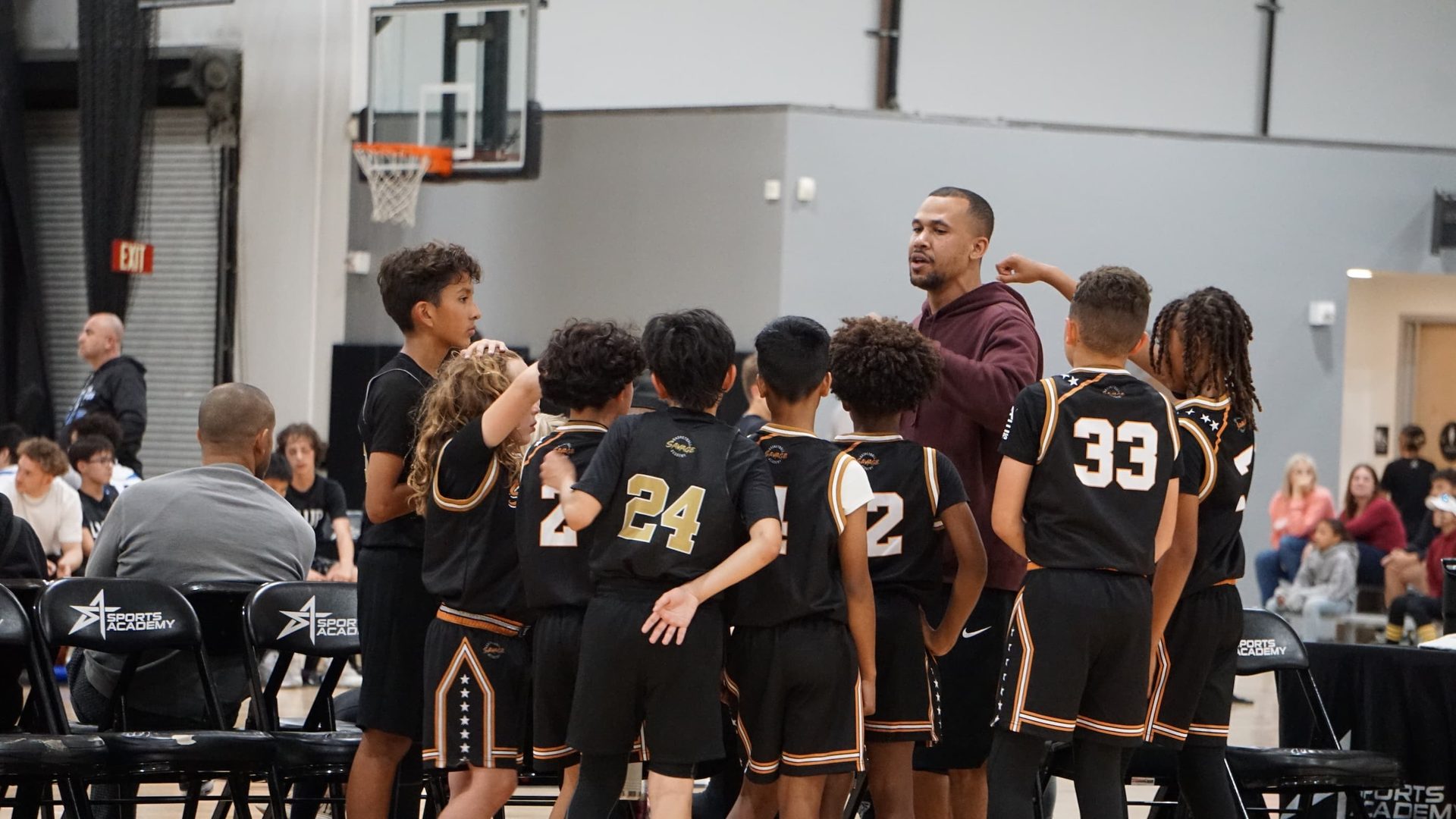 Savage Basketball Academy coach huddle with the team